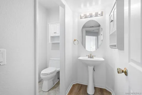 a bathroom with a toilet sink and mirror