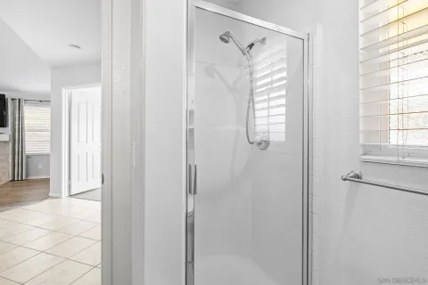 a bathroom with a shower and a shower