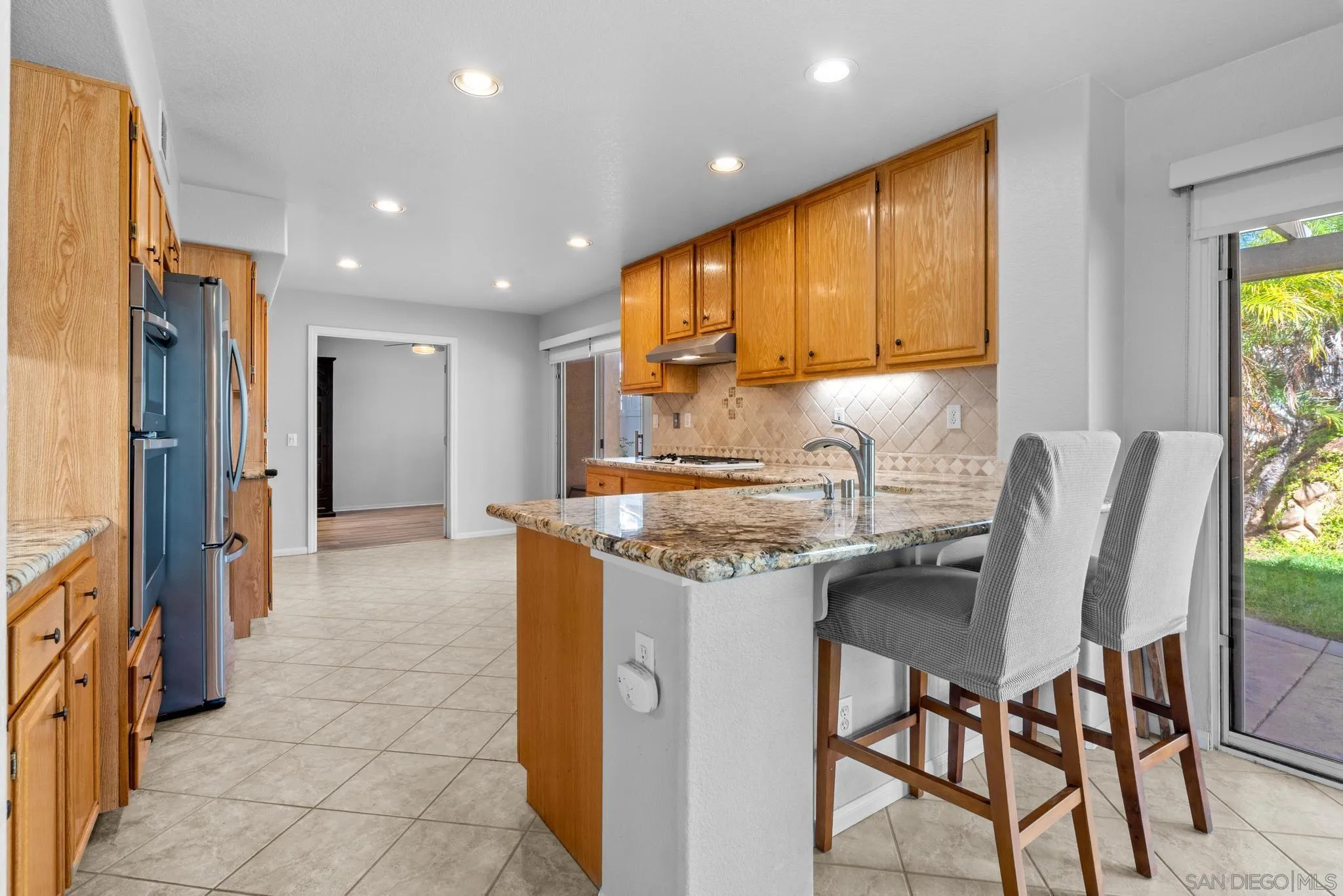 2028 Boulders Road Alpine, CA 91901 - Photo 20 of 56 a kitchen with stainless steel appliances granite countertop a sink and a refrigerator