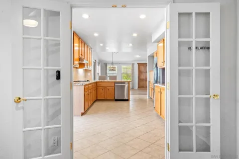 an empty room with wooden floor ceiling fan and windows
