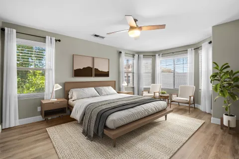 a bedroom with a bed and a chandelier