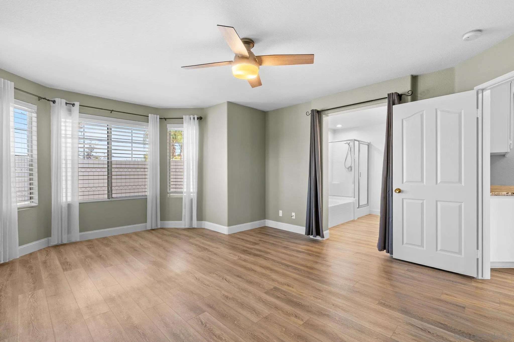 2028 Boulders Road Alpine, CA 91901 - Photo 29 of 56 a view of an empty room with wooden floor and a window