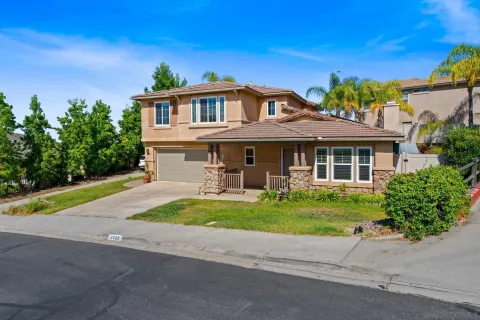 a front view of a house with a yard and porch