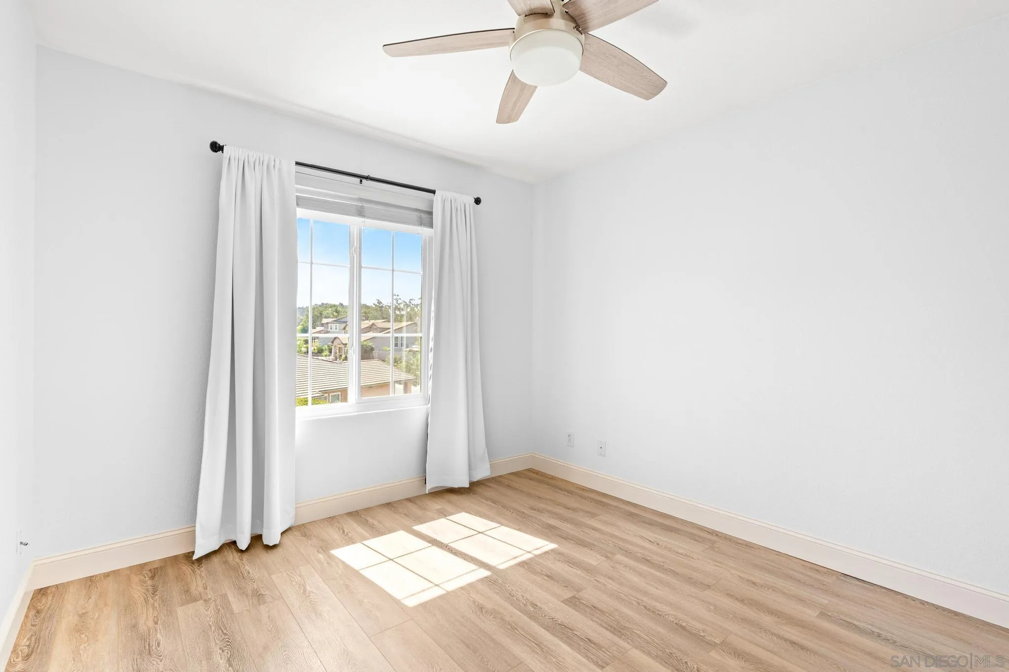 2028 Boulders Road Alpine, CA 91901 - Photo 34 of 56 a view of empty room with wooden floor and fan
