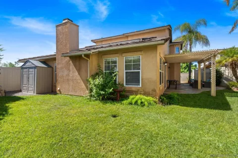 an aerial view of a house with a yard and potted plants