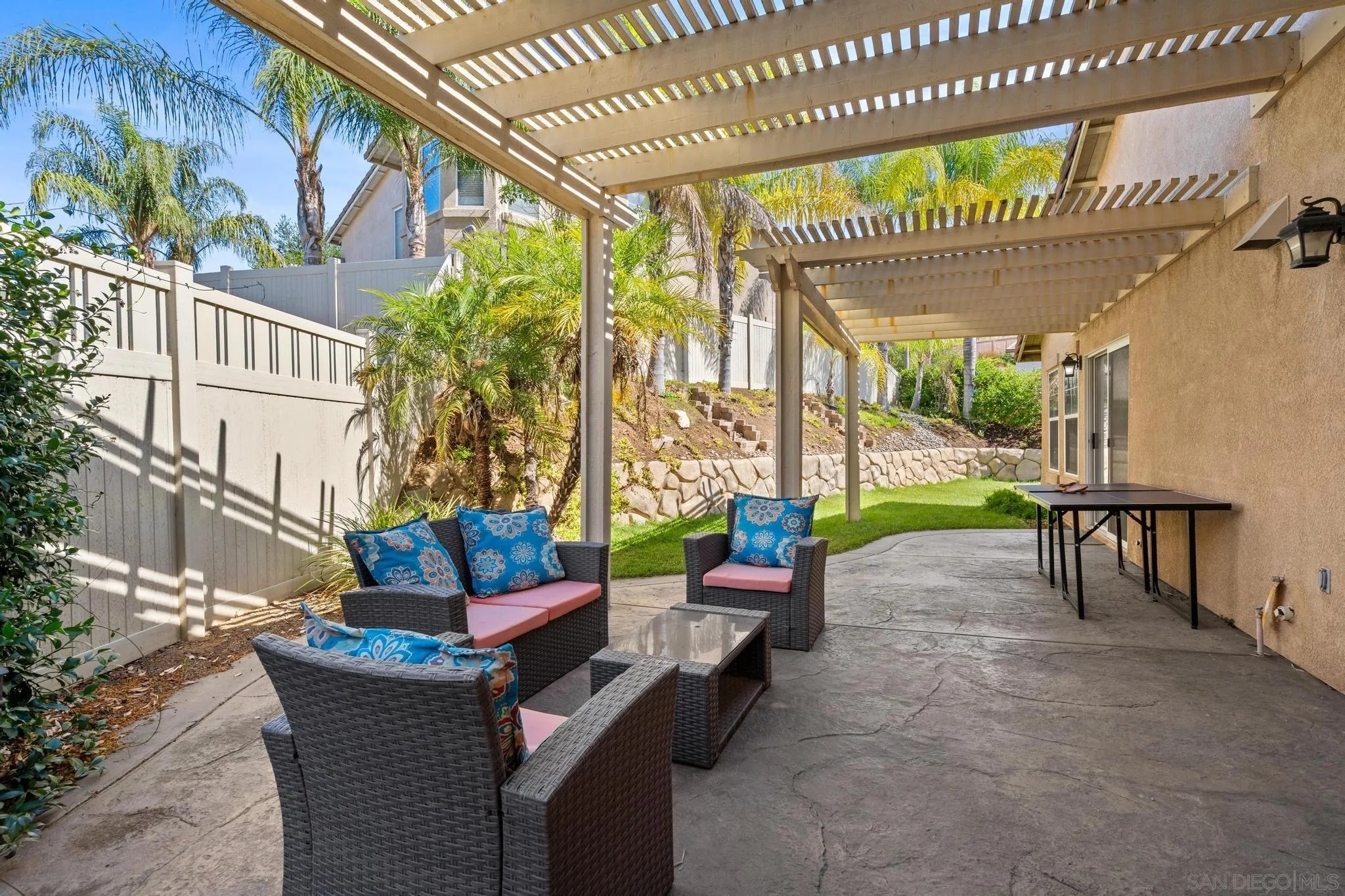 2028 Boulders Road Alpine, CA 91901 - Photo 43 of 56 a view of a chairs and table in the back yard of the house