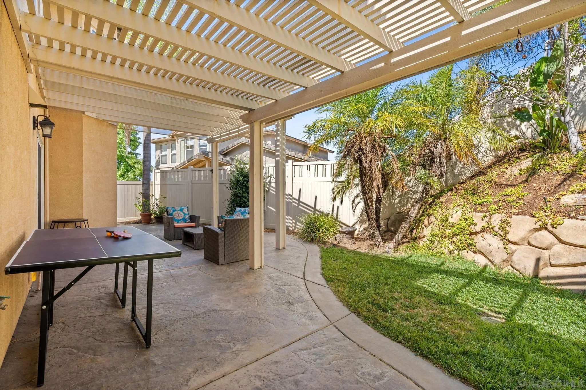 2028 Boulders Road Alpine, CA 91901 - Photo 45 of 56 a view of a patio with table and chairs and potted plants