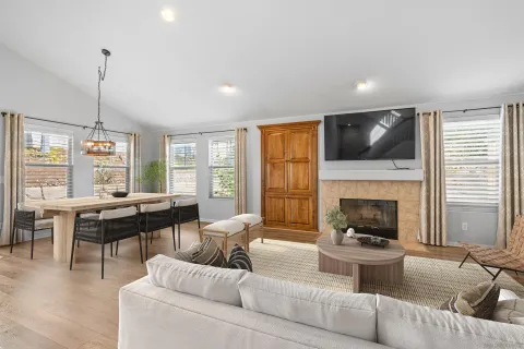 a living room with furniture a fireplace and a flat screen tv
