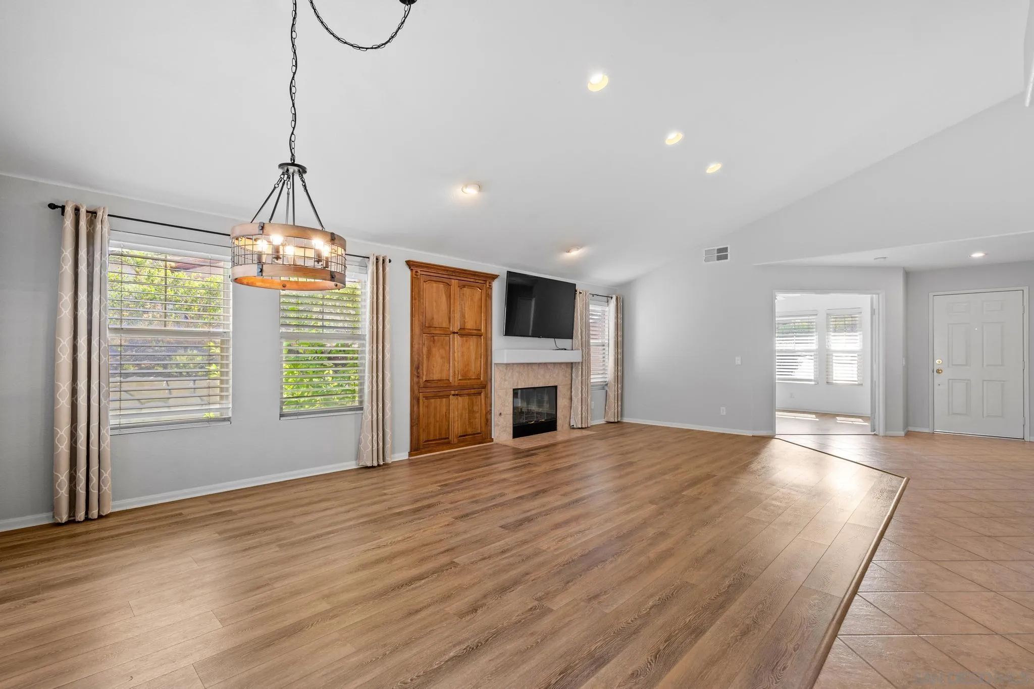 2028 Boulders Road Alpine, CA 91901 - Photo 8 of 56 a view of empty room with wooden floor and fireplace