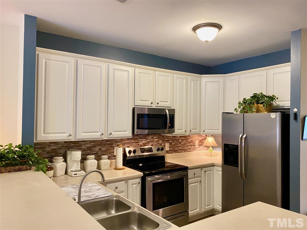 2746 Andover Glen Road Raleigh, NC 27604 - Photo 14 of 30 a kitchen with granite countertop a stove sink and refrigerator