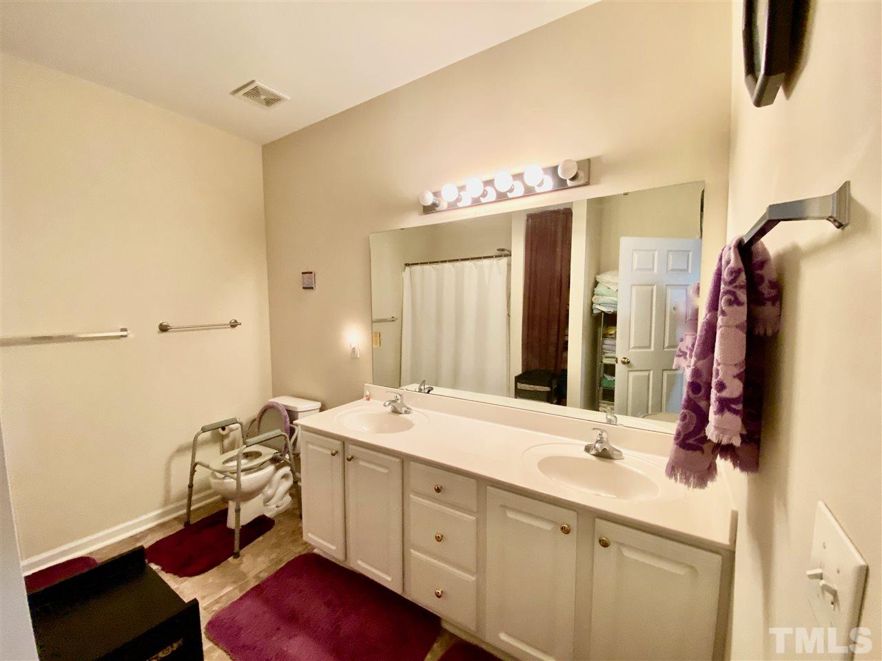 2746 Andover Glen Road Raleigh, NC 27604 - Photo 17 of 30 a bathroom with a double vanity sink and mirror