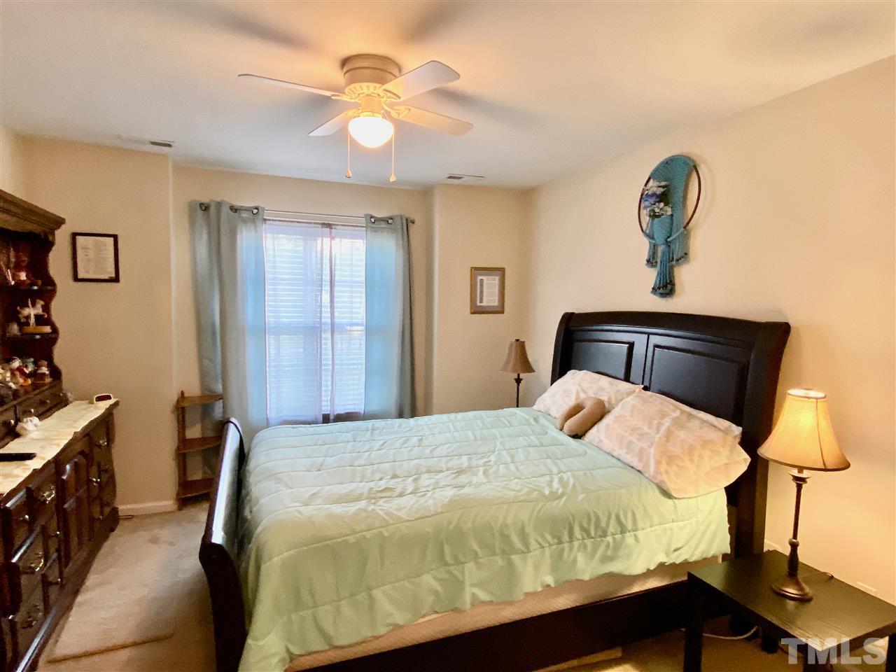 2746 Andover Glen Road Raleigh, NC 27604 - Photo 19 of 30 a bedroom with a bed and a chandelier
