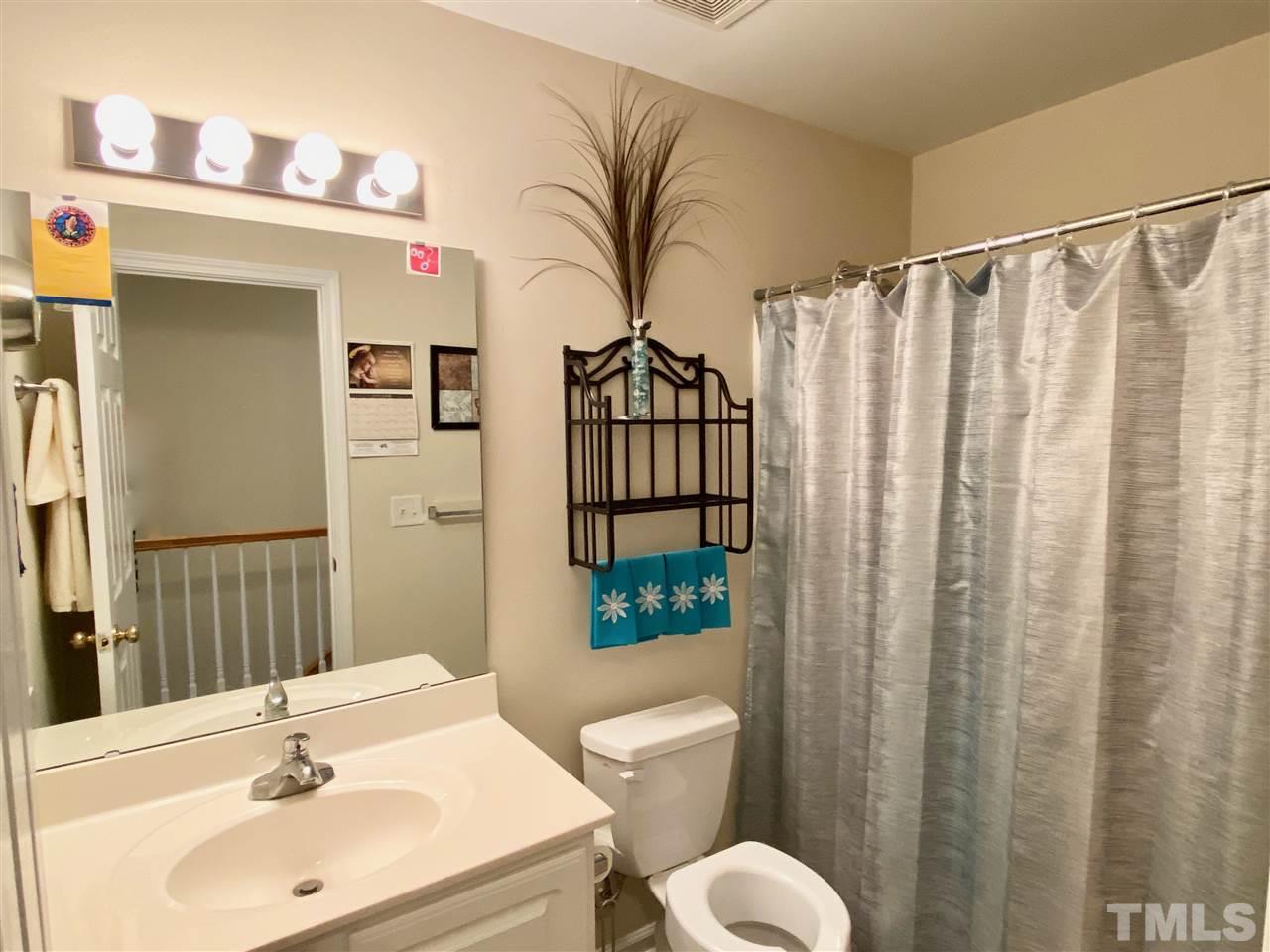 2746 Andover Glen Road Raleigh, NC 27604 - Photo 20 of 30 a bathroom with a sink a toilet and shower curtain