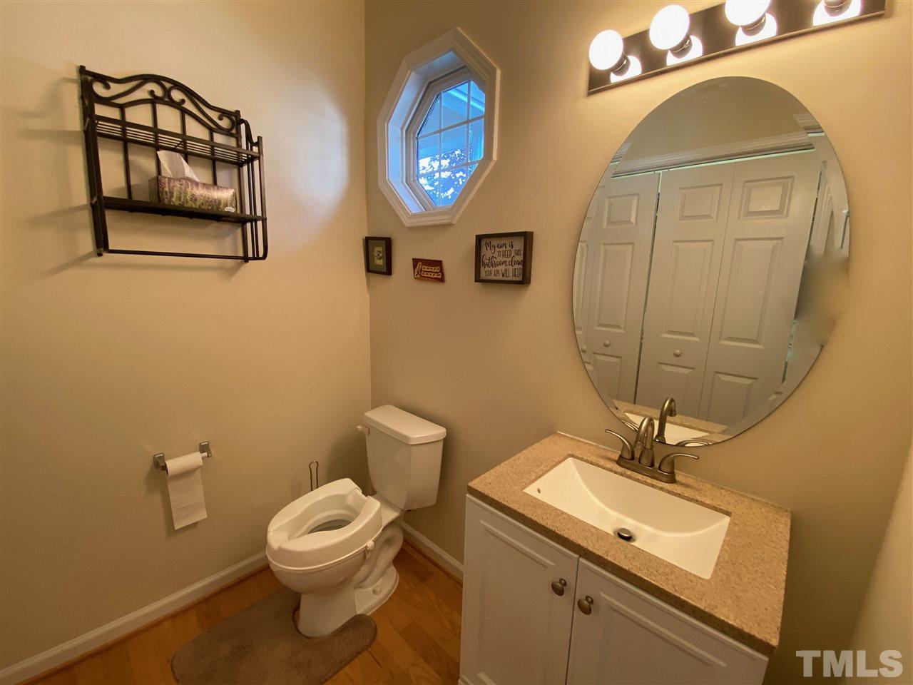 2746 Andover Glen Road Raleigh, NC 27604 - Photo 22 of 30 a bathroom with a toilet a sink and mirror