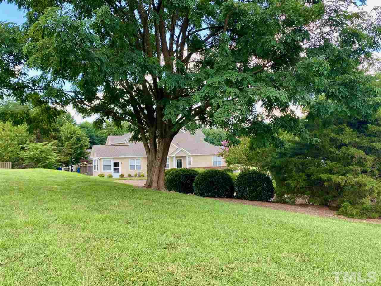 2746 Andover Glen Road Raleigh, NC 27604 - Photo 28 of 30 a view of a backyard with a garden and tree