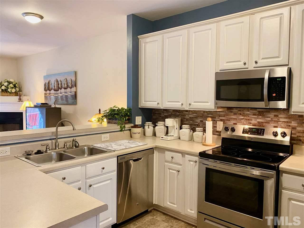 2746 Andover Glen Road Raleigh, NC 27604 - Photo 10 of 30 a kitchen with stainless steel appliances granite countertop a sink stove and microwave