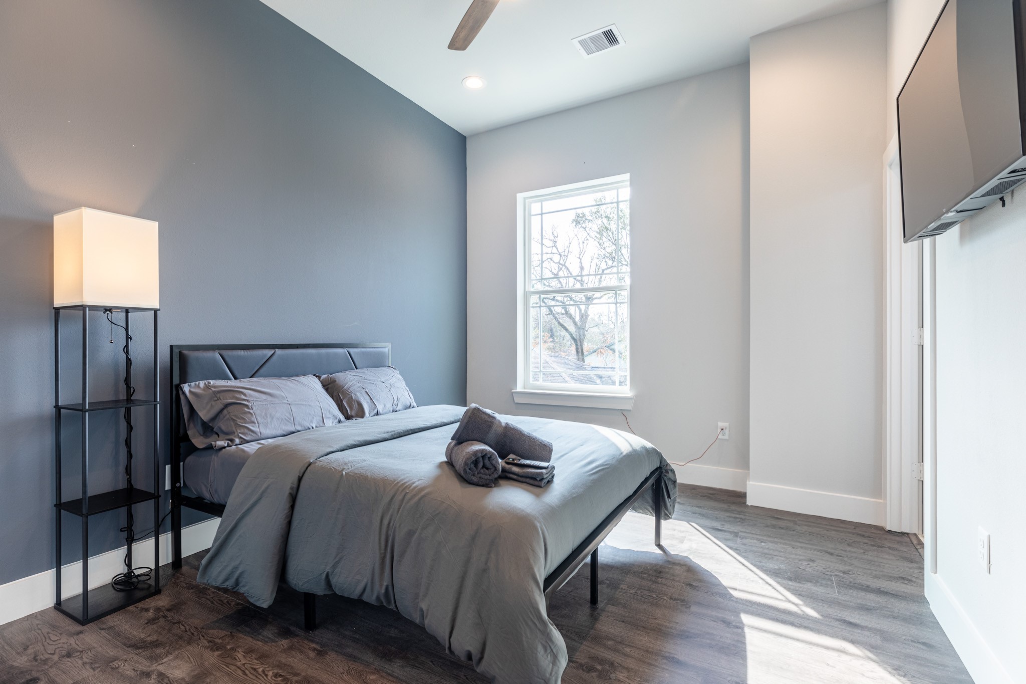 a bedroom with a bed and wooden floor