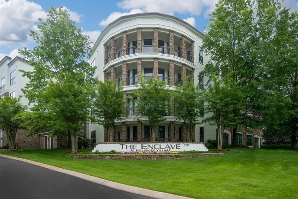 a front view of a building with a garden
