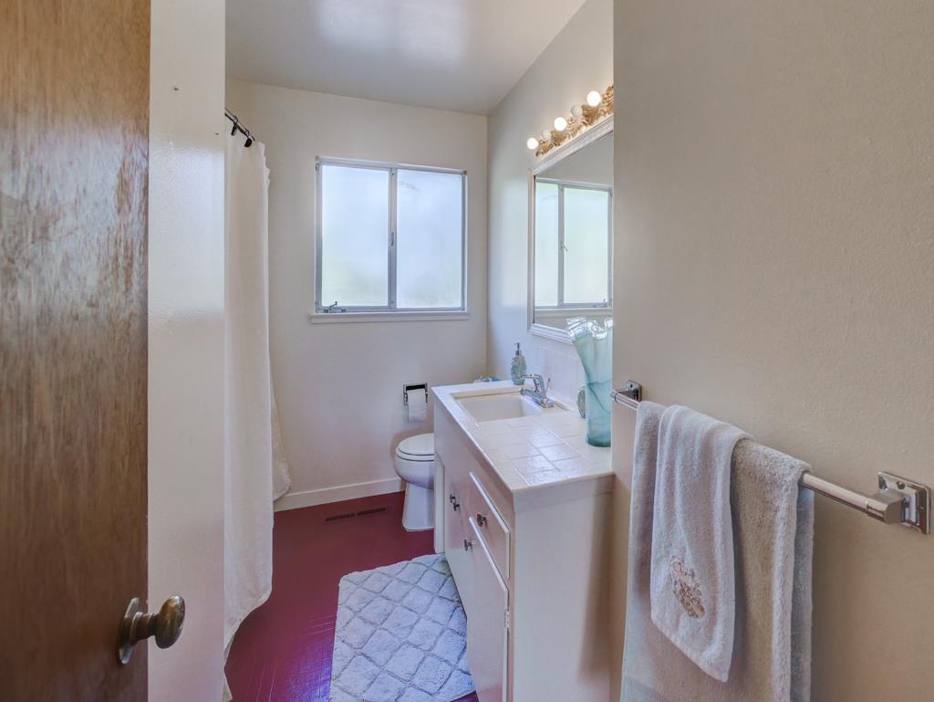 16 Oak Road Santa Cruz, CA 95060 - Photo 12 of 27 a en suite bathroom with a granite countertop sink a toilet and a mirror