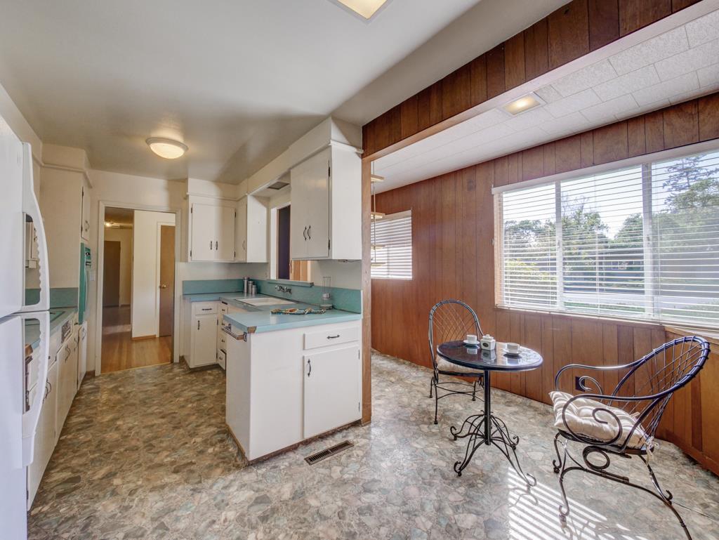 16 Oak Road Santa Cruz, CA 95060 - Photo 10 of 27 a living room with furniture a flat screen tv and large window