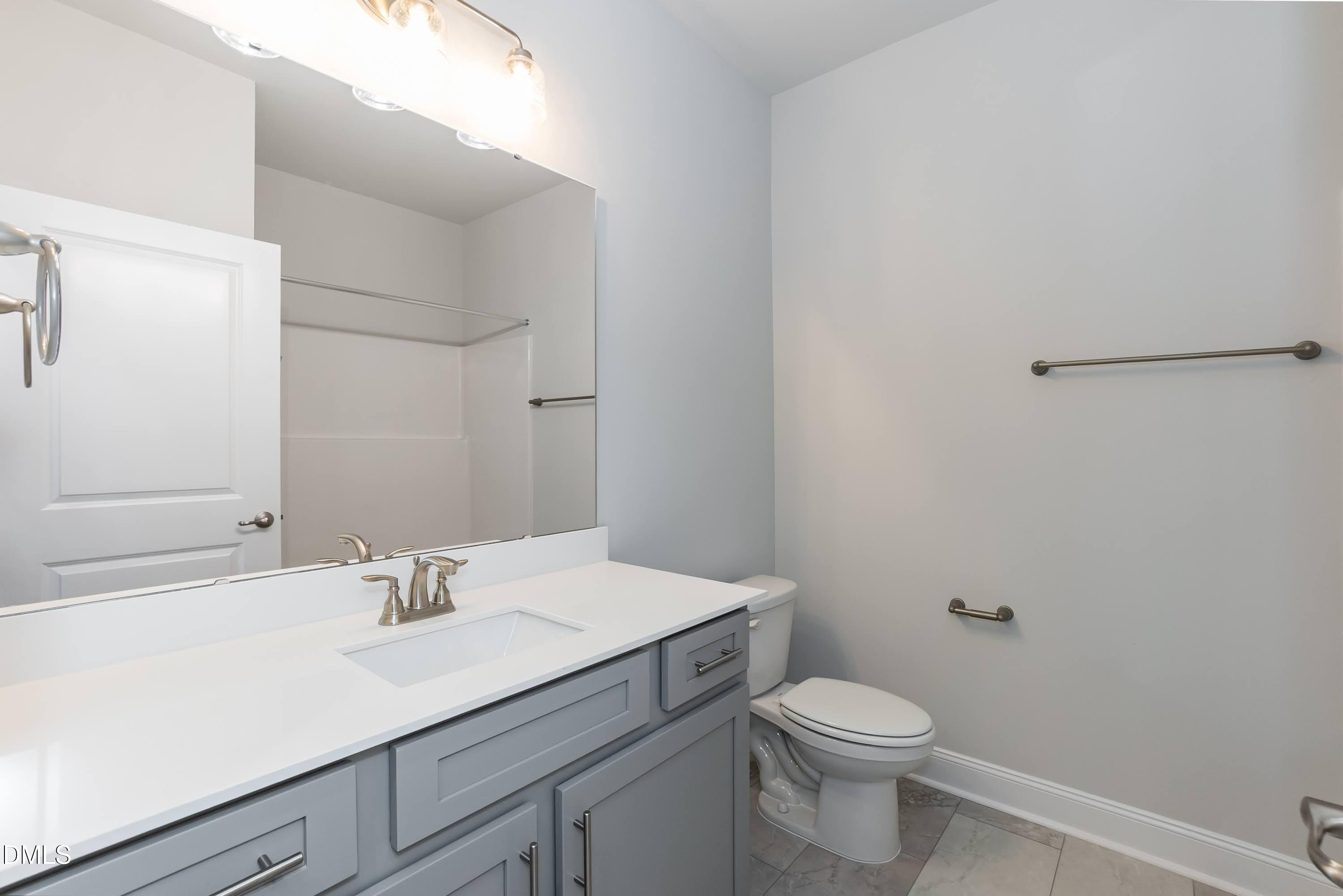 1 Galway Road Lillington, NC 27546 - Photo 24 of 30 a bathroom with a sink a toilet and mirror
