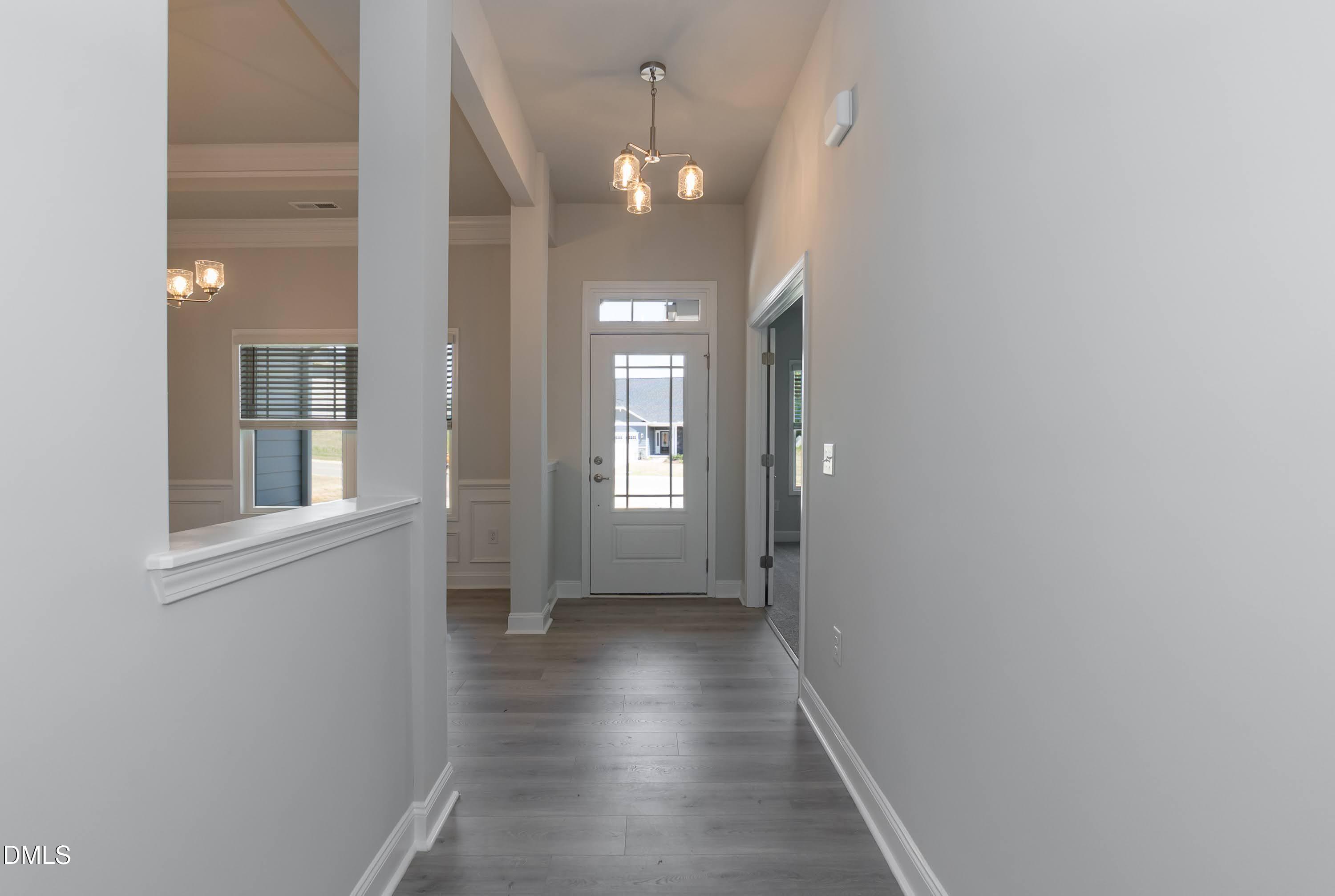 1 Galway Road Lillington, NC 27546 - Photo 3 of 30 a view of a hallway with wooden floor and a chandelier