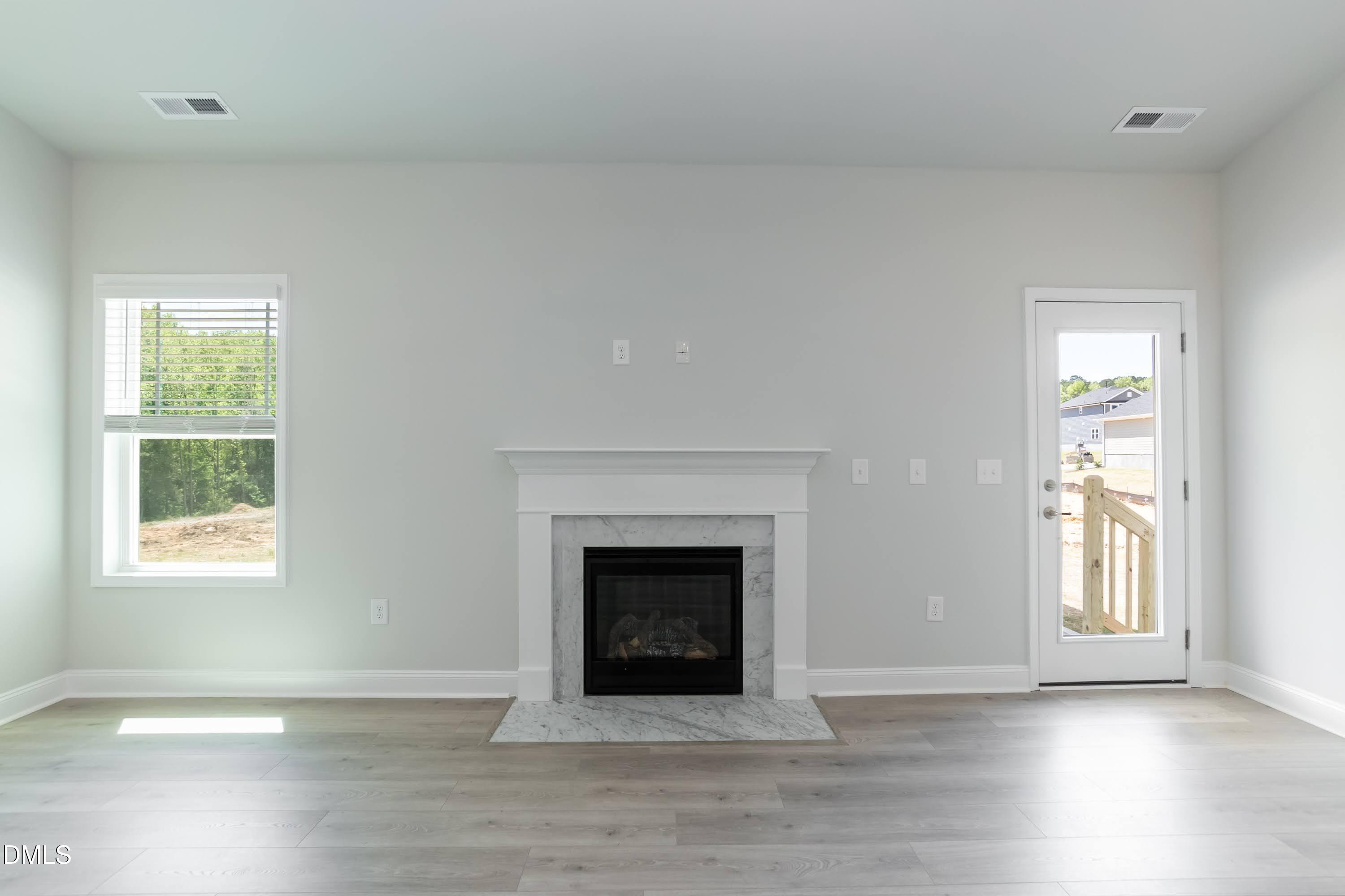 1 Galway Road Lillington, NC 27546 - Photo 9 of 30 an empty room with windows and fireplace