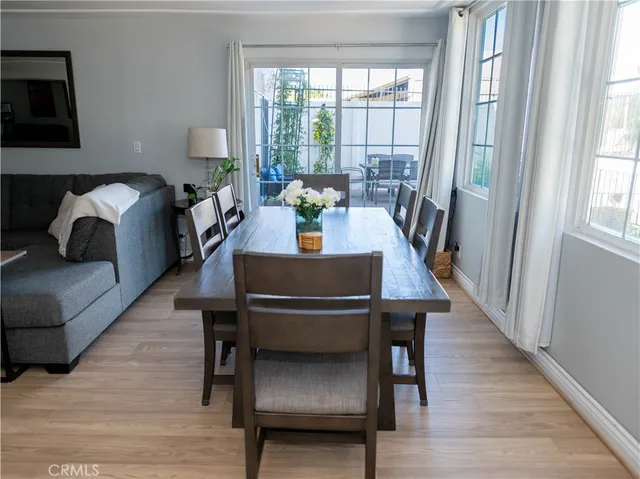 a white toilet sitting next to a bathroom sink and a mirror