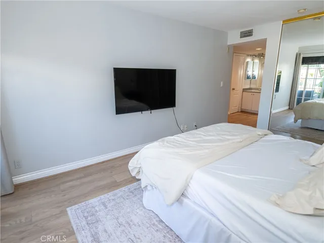 a bathroom with a granite countertop sink a mirror and a shower