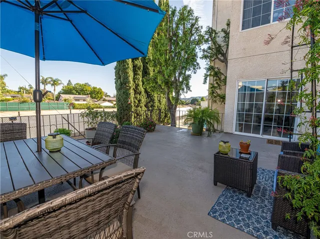 a balcony with trees in front of main door