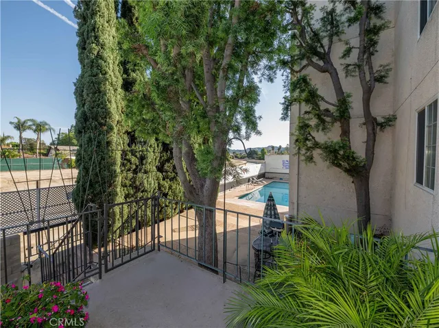 a view of balcony with wooden floor and potted plants