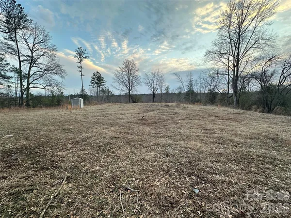 a view of dirt yard with a fountain