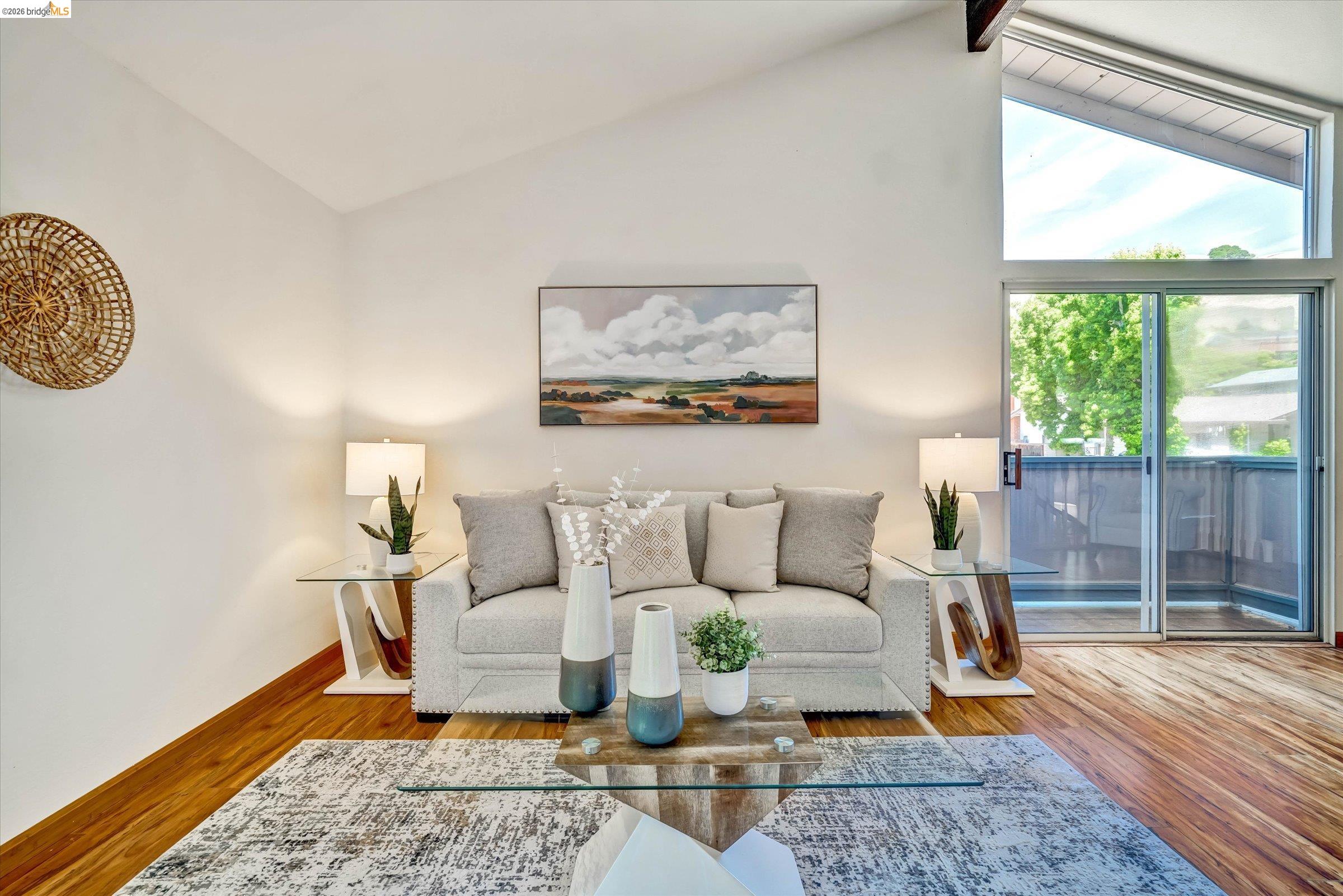 2826 Wright Avenue Pinole, CA 94564 - Photo 40 of 70 Vaulted ceiling living area with a large sliding glass door, a triangular transom window, and wood-finish flooring