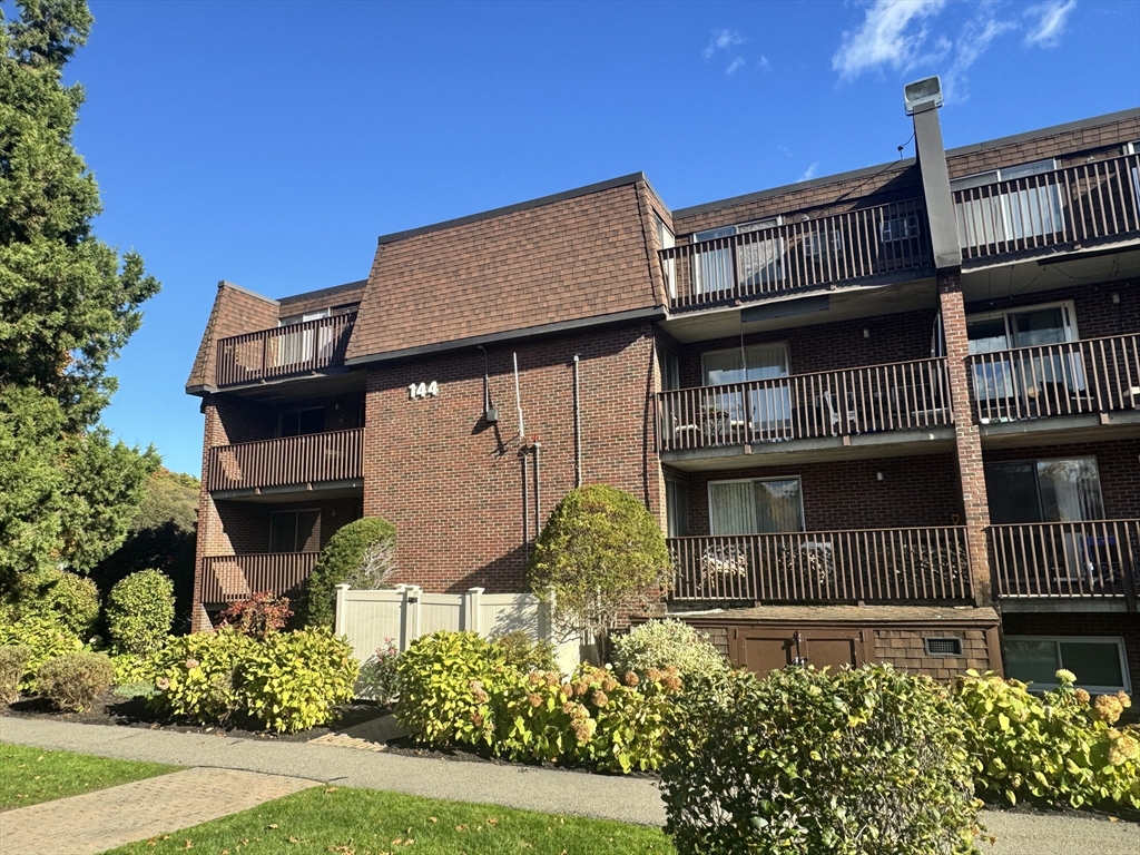 144 Kenrick Street, Unit 12 Boston, MA 02135 - Photo 1 of 11 front view of a house