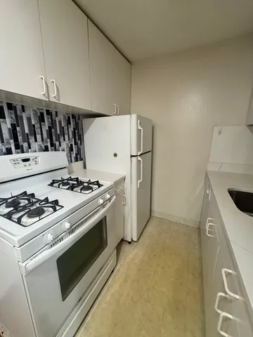 a kitchen with a stove and a refrigerator