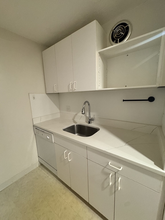 144 Kenrick Street, Unit 12 Boston, MA 02135 - Photo 4 of 11 a kitchen with a sink and cabinets