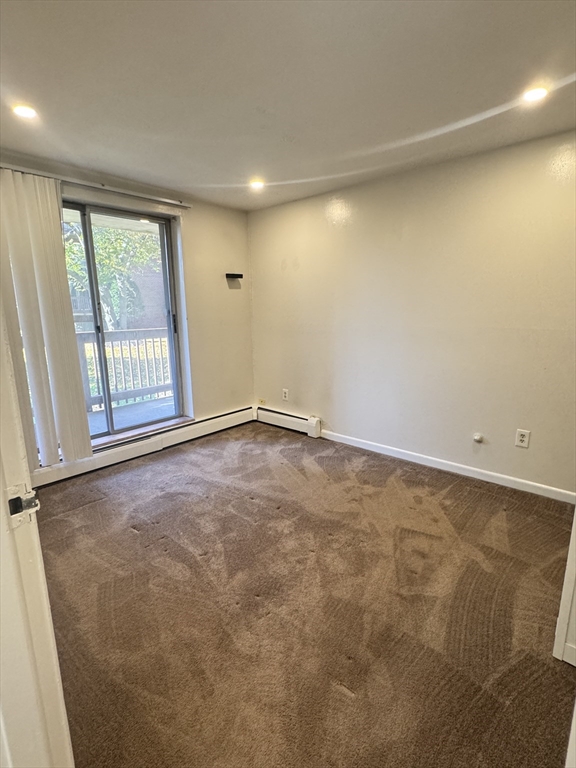 144 Kenrick Street, Unit 12 Boston, MA 02135 - Photo 6 of 11 an empty room with windows