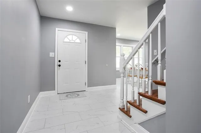 a view of a dining room with furniture and window