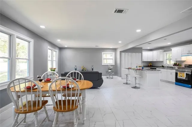 a dining room with a window and chairs