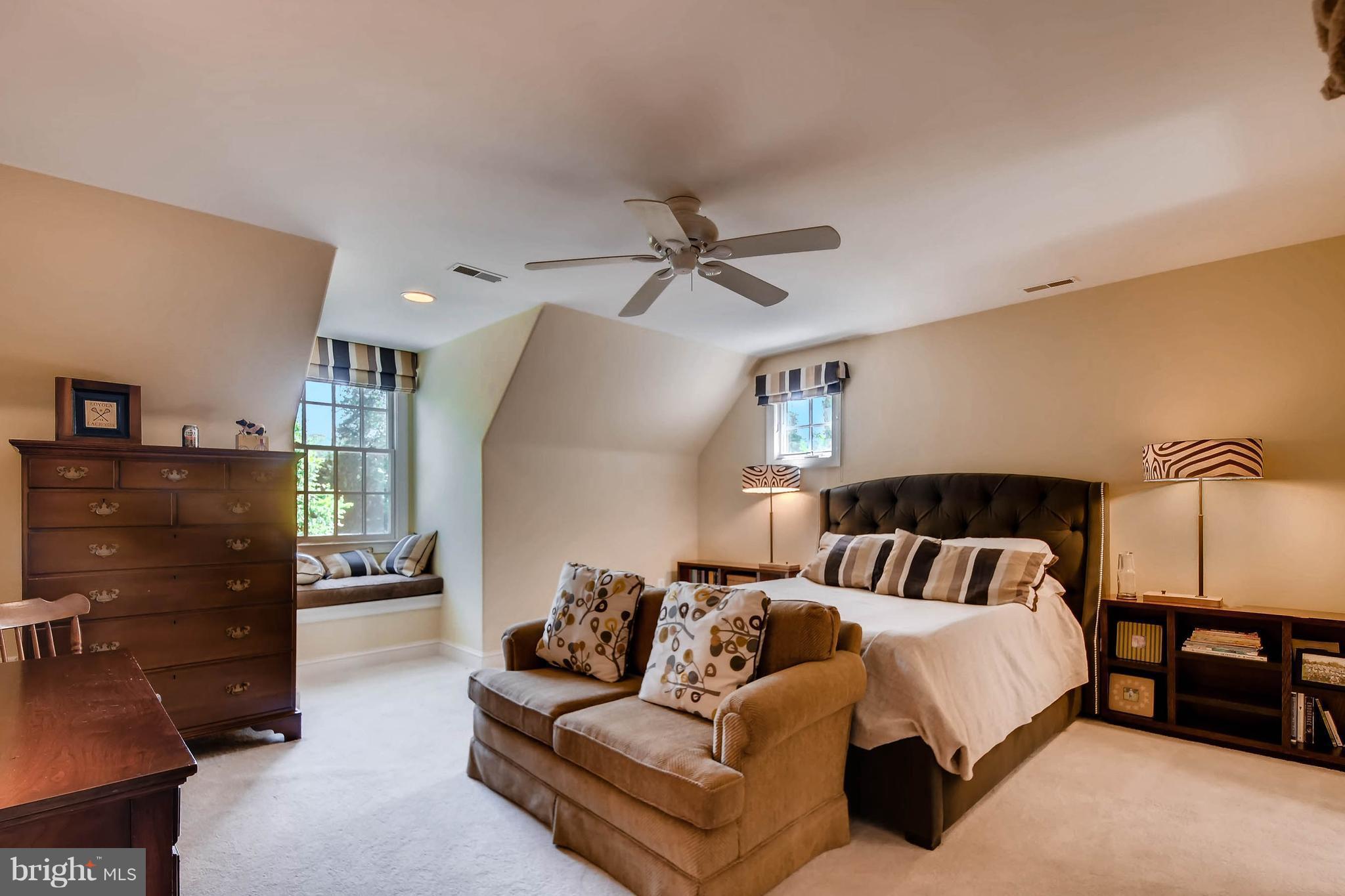 7812 Ruxwood Road Baltimore, MD 21204 - Photo 22 of 30 a spacious bedroom with a bed and a ceiling fan