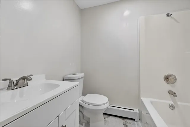 a white toilet sitting next to a bathroom sink