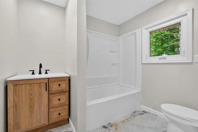 a bathroom with a sink a toilet and bathtub