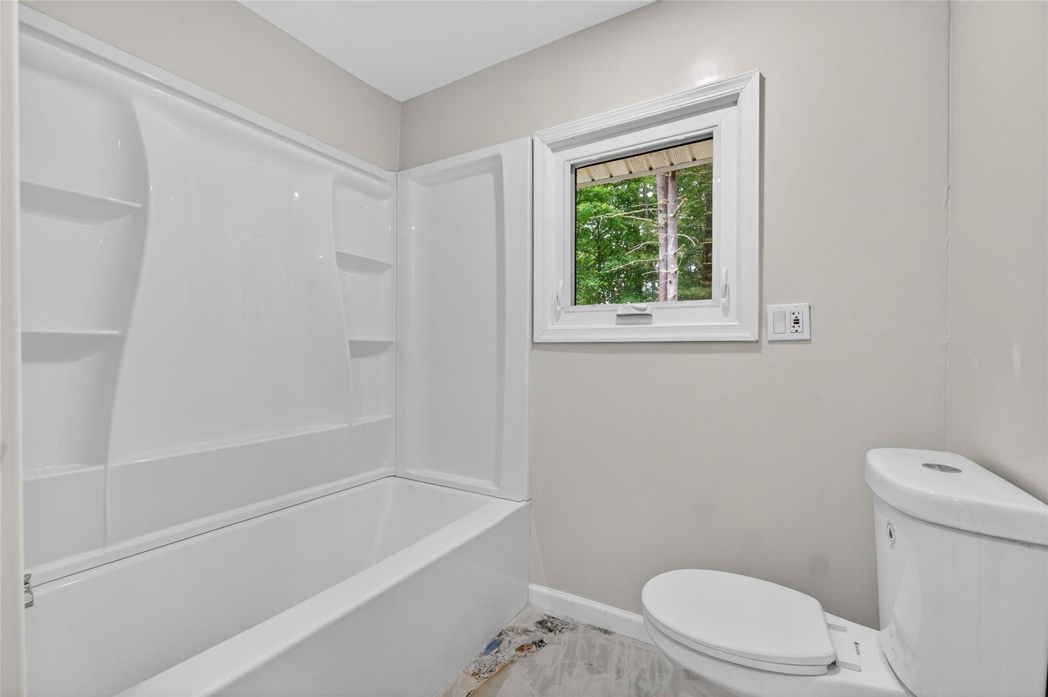 52 Luxton Lake Road Narrowsburg, NY 12764 - Photo 22 of 38 a white toilet sitting next to a bath tub
