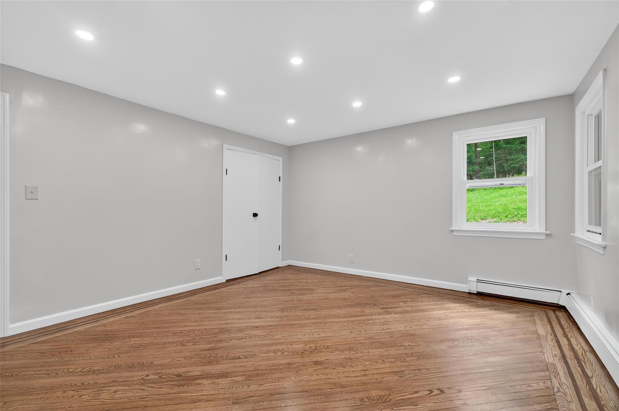 52 Luxton Lake Road Narrowsburg, NY 12764 - Photo 24 of 38 an empty room with wooden floor and windows