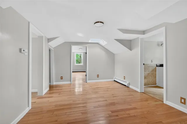 a view of an empty room and wooden floor