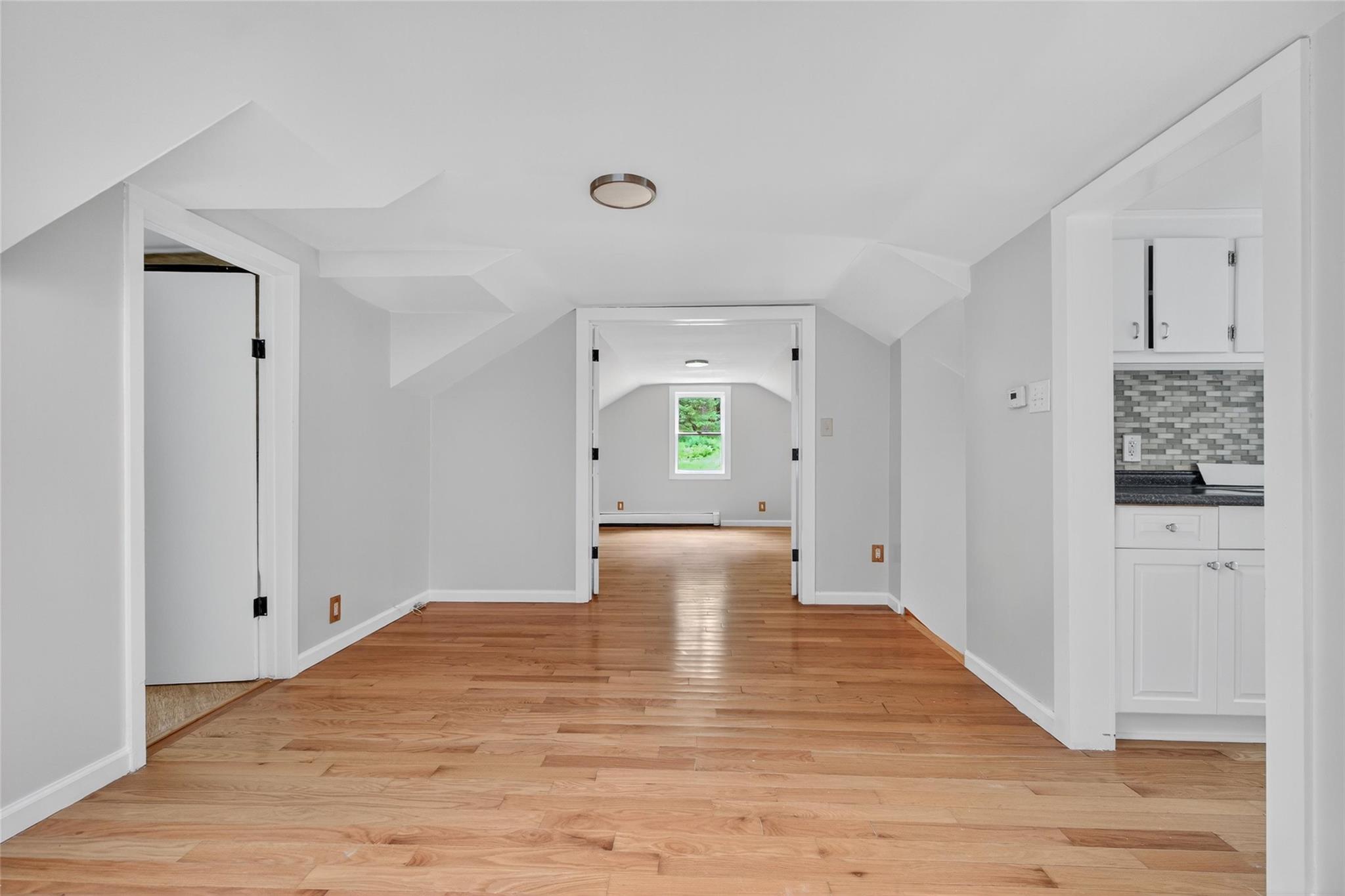 52 Luxton Lake Road Narrowsburg, NY 12764 - Photo 28 of 38 a view of a hallway with wooden floor and cabinet