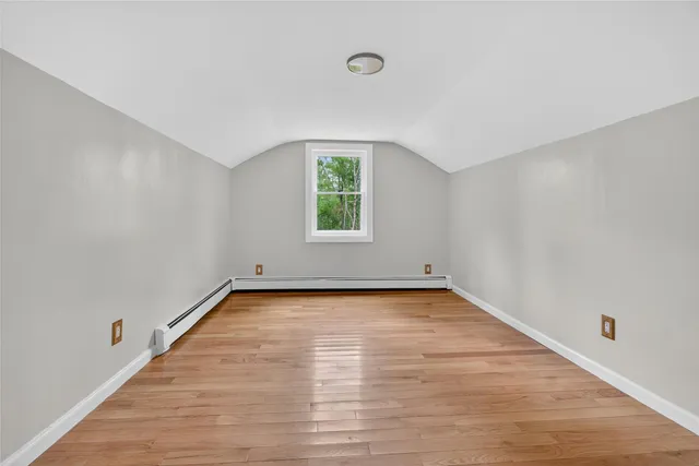 a view of a room with wooden floor and window