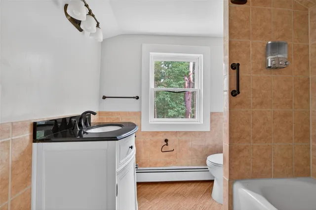a bathroom with a sink a toilet and tub