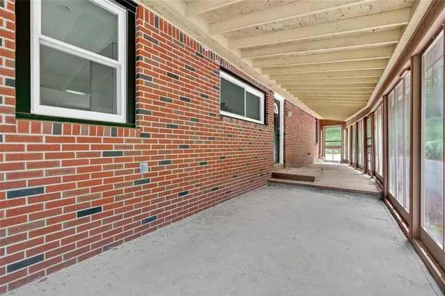 a view of a patio with table and chairs