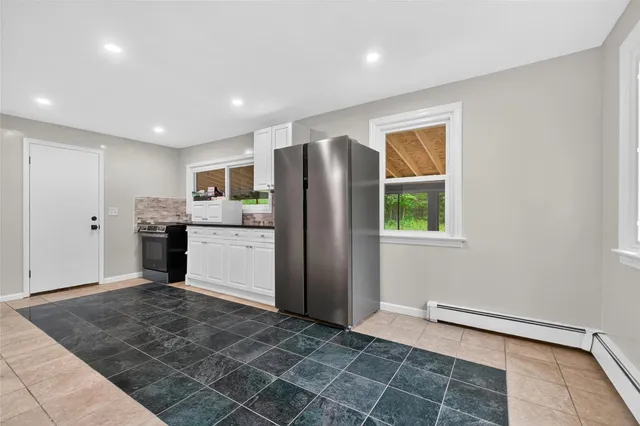 a kitchen with stainless steel appliances granite countertop a refrigerator and a sink